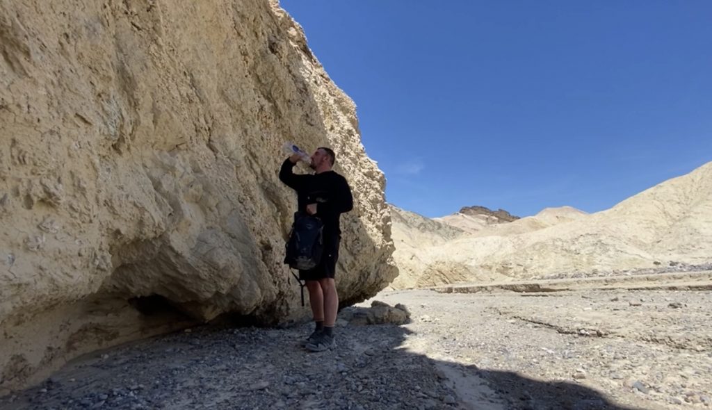Drinking Water While hiking in the Summer Heat. Death Valley